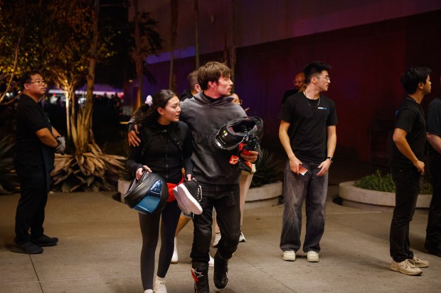 People leave while police investigate a shooting incident at Valley...