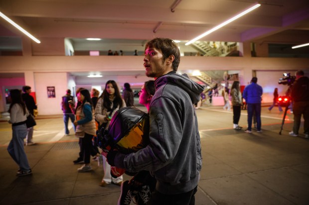 People leave while police investigate a shooting incident at Valley...