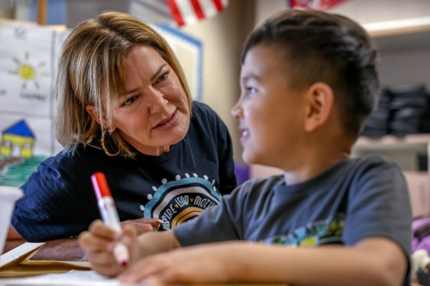 Corina Martinez talks to Ryan Hemmati, 5, during her class at Pioneer Elementary School in Escondido on Thursday, Nov. 6, 2025. (Hayne Palmour IV / For The San Diego Union-Tribune)
