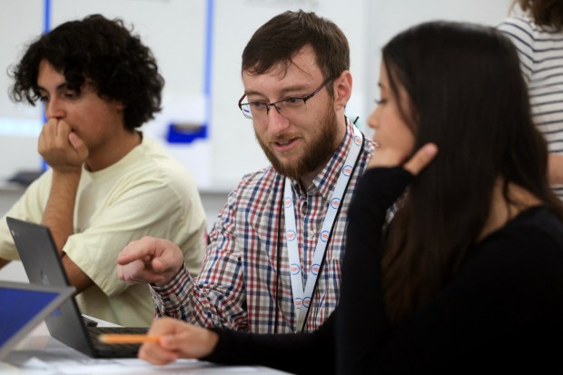 Gregory Hinchliff works with student Halle Toci, 15, during his Native American studies class at Bonsall High School on Thursday, Nov. 6, 2025. (Hayne Palmour IV / For The San Diego Union-Tribune)