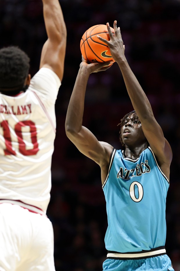 SDSU sophomore Magoon Gwath shoots against Tory's Jerrell Bellamy on Tuesday night at Viejas Arena. (Meg McLaughlin / The San Diego Union-Tribune)