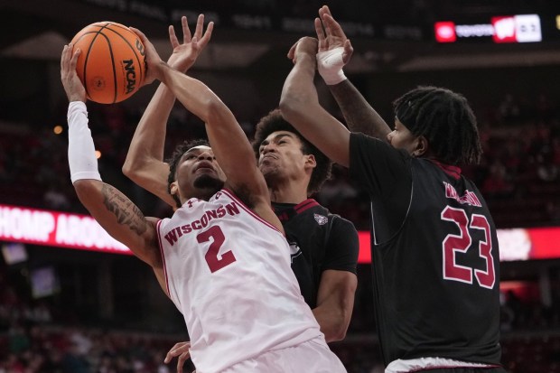 Wisconsin's Nick Boyd shoots past Northern Illinois' Ladji Kante and Jaylen Wharton during the second half of an NCAA college basketball game Friday, Nov. 7, 2025, in Madison, Wis. (AP Photo/Morry Gash)