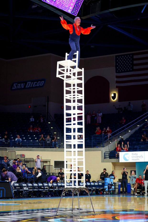 Gary Sladek performs the "death-defying tower of chairs" routine during the 2025 Rady Children's Invitational at the Jenny Craig Pavilion on Thursday, Nov. 27, 2025 in San Diego, California. (Meg McLaughlin / The San Diego Union-Tribune)