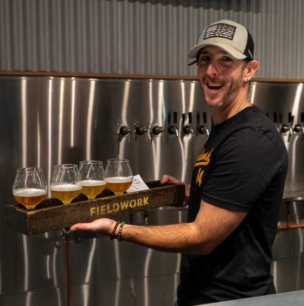 Johnny Ielmorini of Fieldwork Brewing Co. shows off the first...