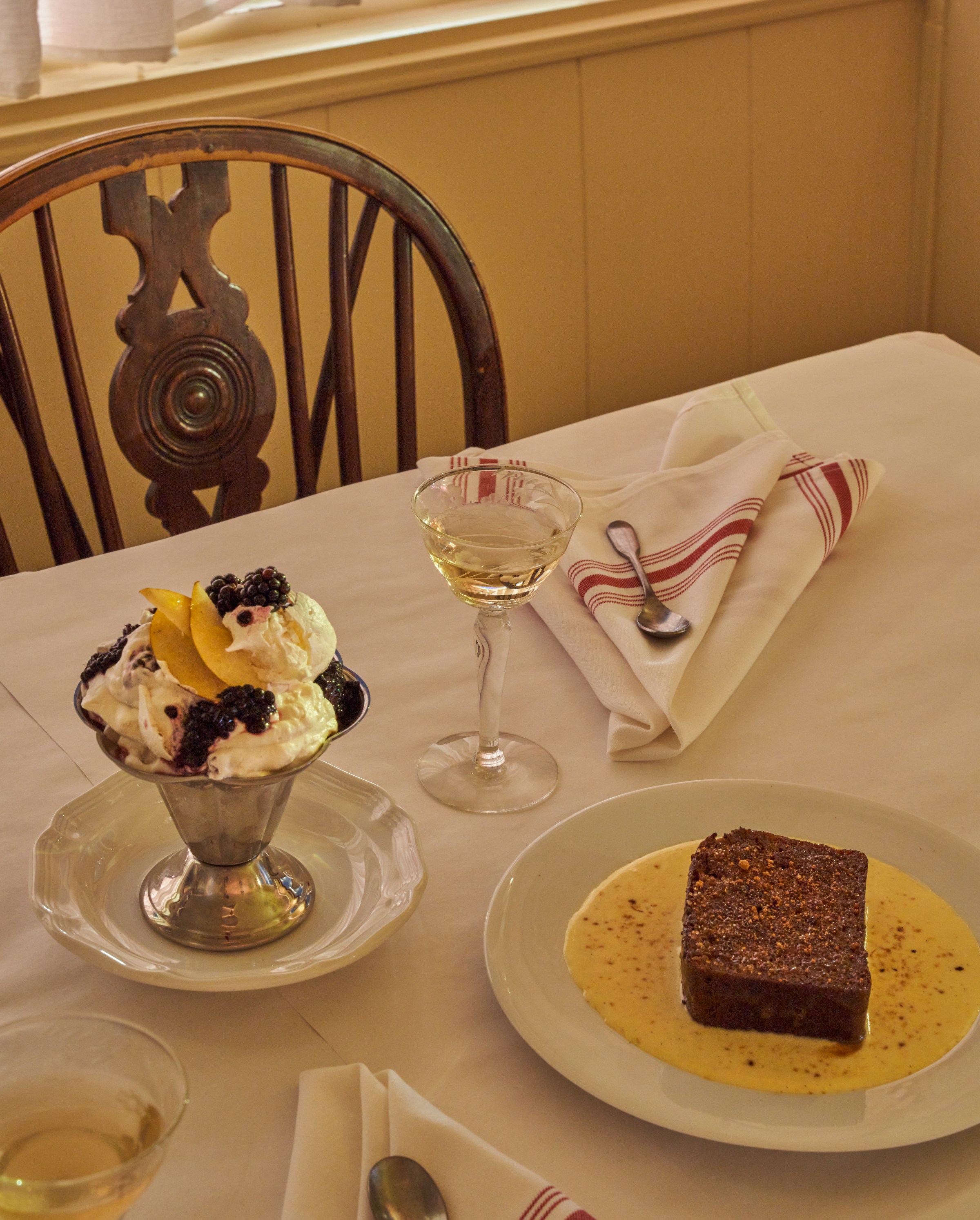 Eton mess and sticky toffee pudding on a white table at Wilde’s