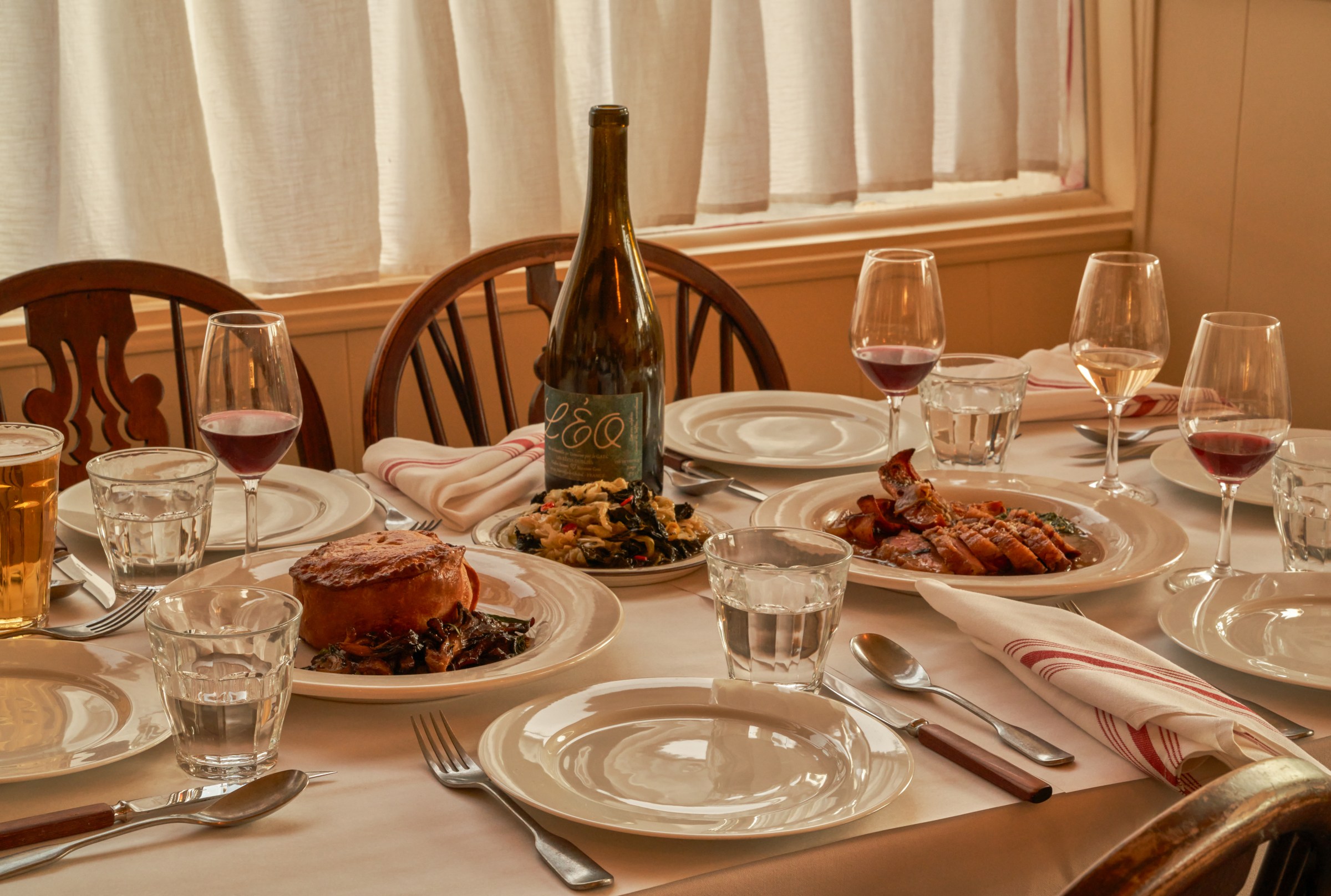 Spread of dishes and wine on a table at Wilde’s