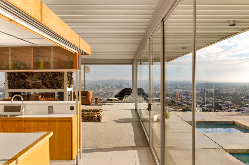 Modern interior space with scenic city views and outdoor pool.