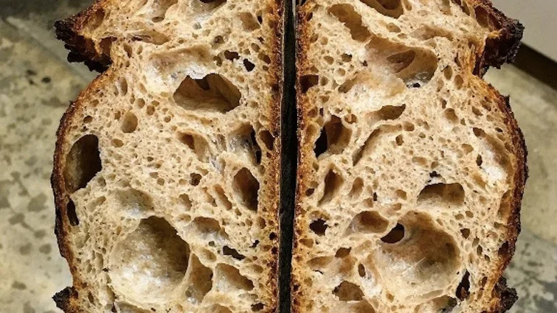 The inside of a cut loaf of Josey Baker Bread sourdough stacked next to each other