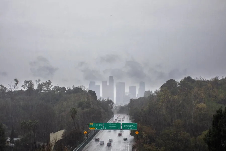 Cars ride the 110 Freeway toward downtown during heavy rain in Los Angeles, California, on November 15, 2025. A multiple-day powerful atmospheric river storm is triggering evacuation due to possible mudslides to areas burned by wildfires and flash flood warnings in Southern California. (Photo by Apu GOMES / AFP) (Photo by APU GOMES/AFP via Getty Images)
