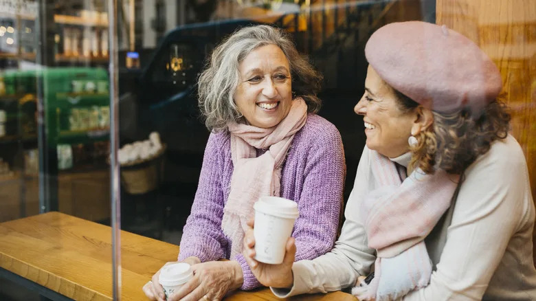 Senior people enjoying coffee in a modern cafe