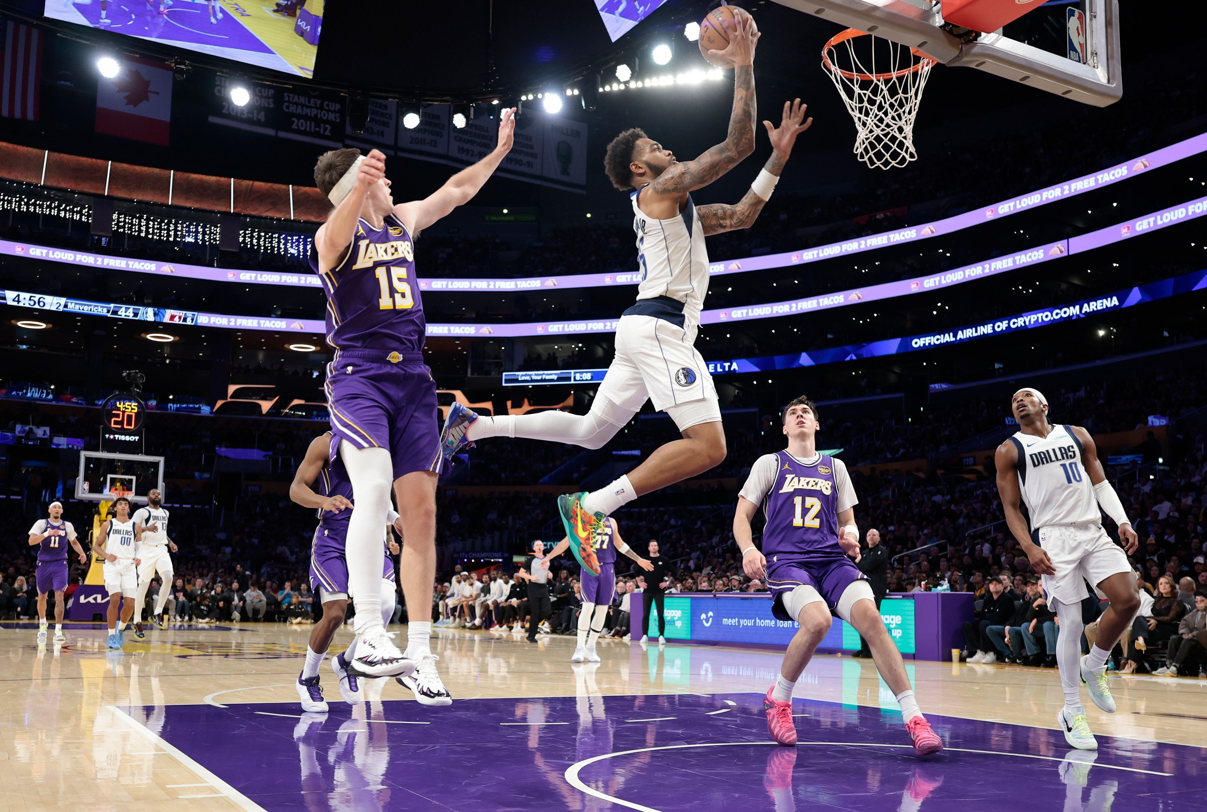 LOS ANGELES, CALIFORNIA - NOVEMBER 28: P.J. Washington #25 of the Dallas Mavericks shoots the ball against Austin Reaves #15 of the Los Angeles Lakers during the second quarter at Crypto.com Arena on November 28, 2025 in Los Angeles, California. NOTE TO USER: User expressly acknowledges and agrees that, by downloading and or using this photograph, User is consenting to the terms and conditions of the Getty Images License Agreement. (Photo by Ronald Martinez/Getty Images)