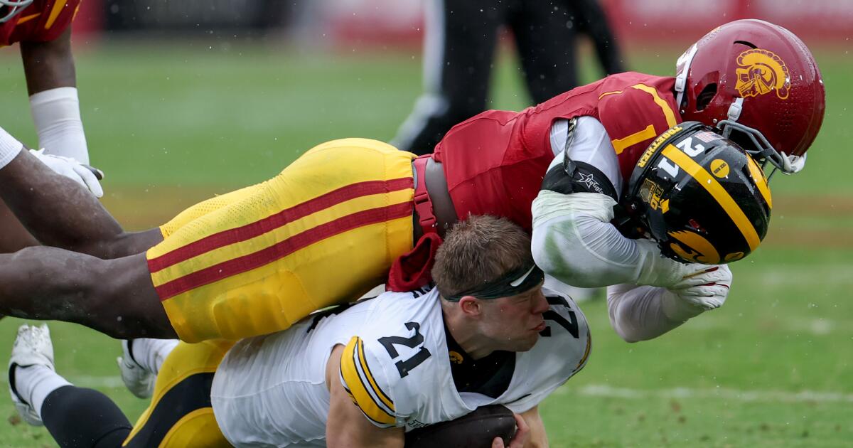 USC keeps playoff hopes alive with downpour of toughness against Iowa
