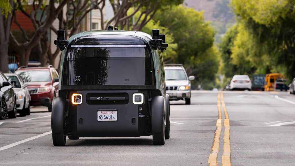 a Zoox robotaxi drives down the street in san francisco