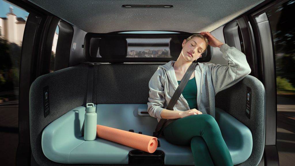 A woman sitting in a Zoox robotaxi