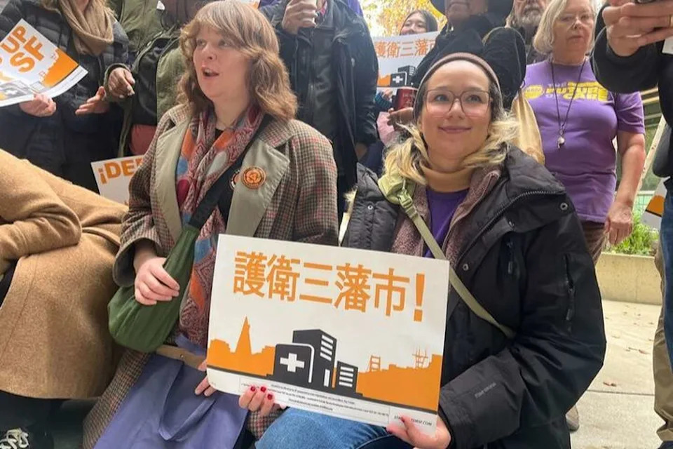 Lauren Kush, right, who made headlines in 2019 as a homeless Uber driver, attends a rally Saturday to put the Overpaid CEO Act on the San Francisco ballot. (St. John Barned-Smith/S.F. Chronicle)