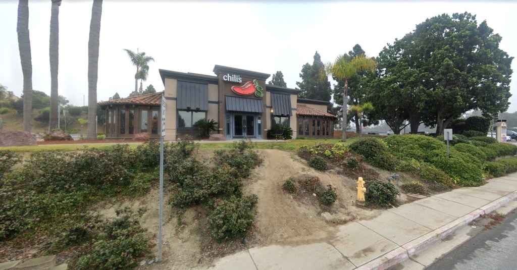 Chili's restaurant with surrounding trees and landscaping, seen from the street.