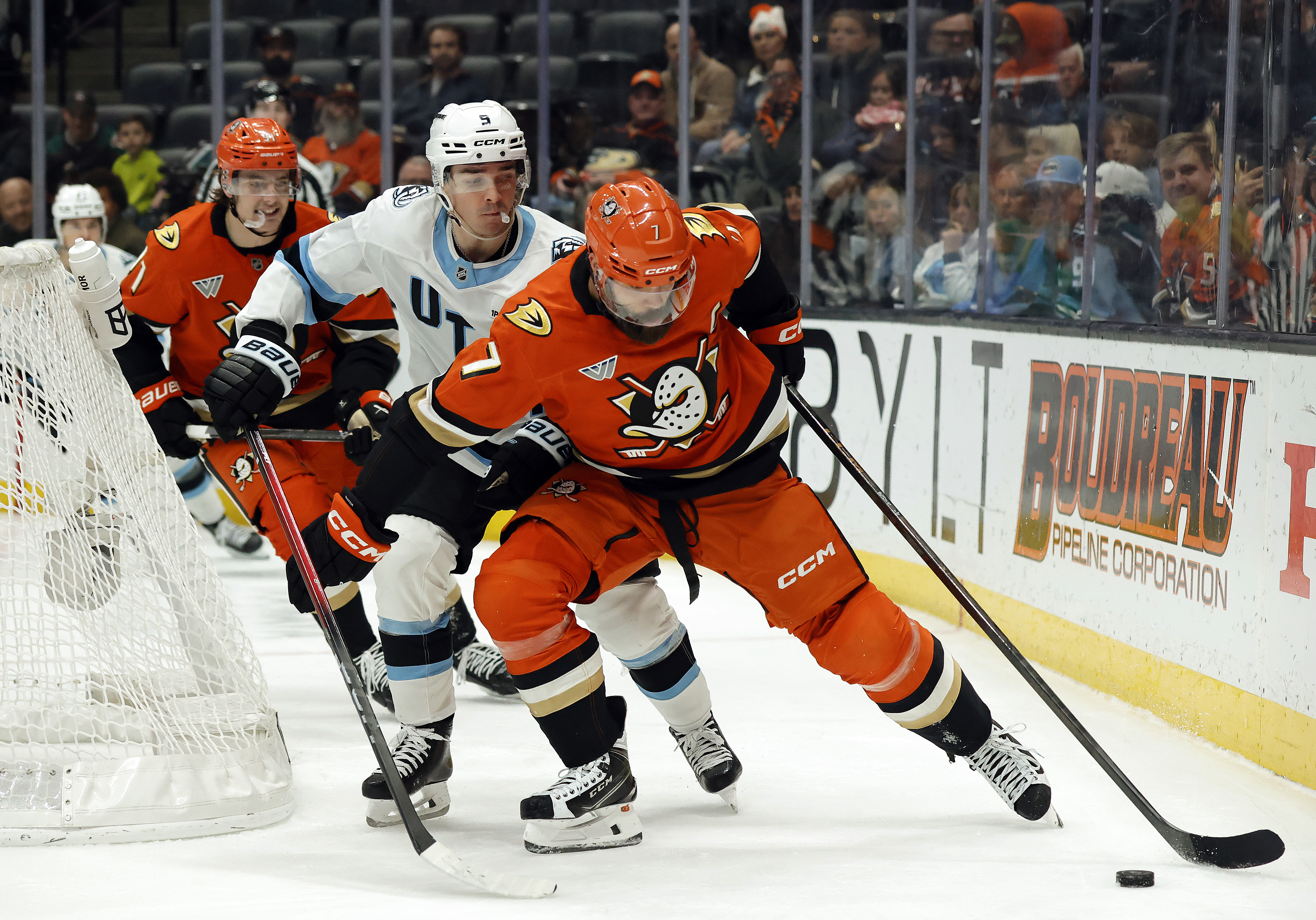 The Ducks’ Radko Gudas, front, skates the puck against the...