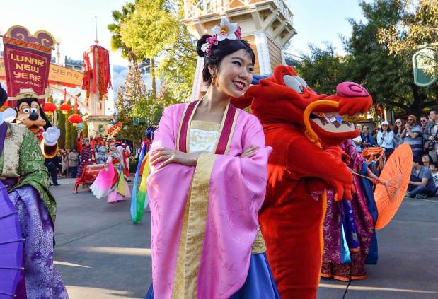 Mulan and Mushu join dancers as they perform during Mulan's Lunar New Year Procession on the first day of Disney's Lunar New Year celebration at California Adventure in Anaheim on Friday, Jan 26, 2018. (Photo by Jeff Gritchen, Orange County Register/SCNG)