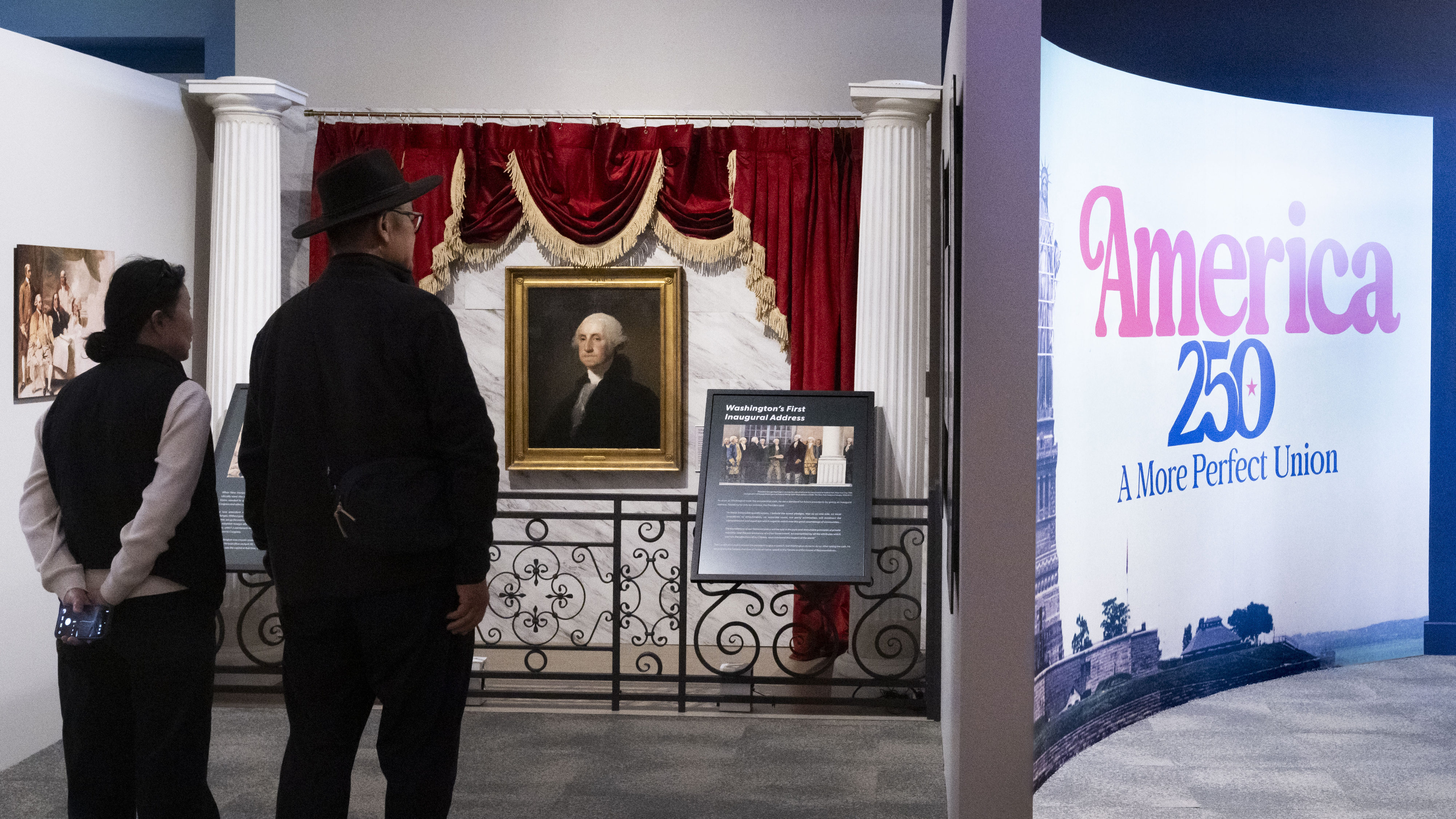 A couple tours the exhibit America 250, A More Perfect...