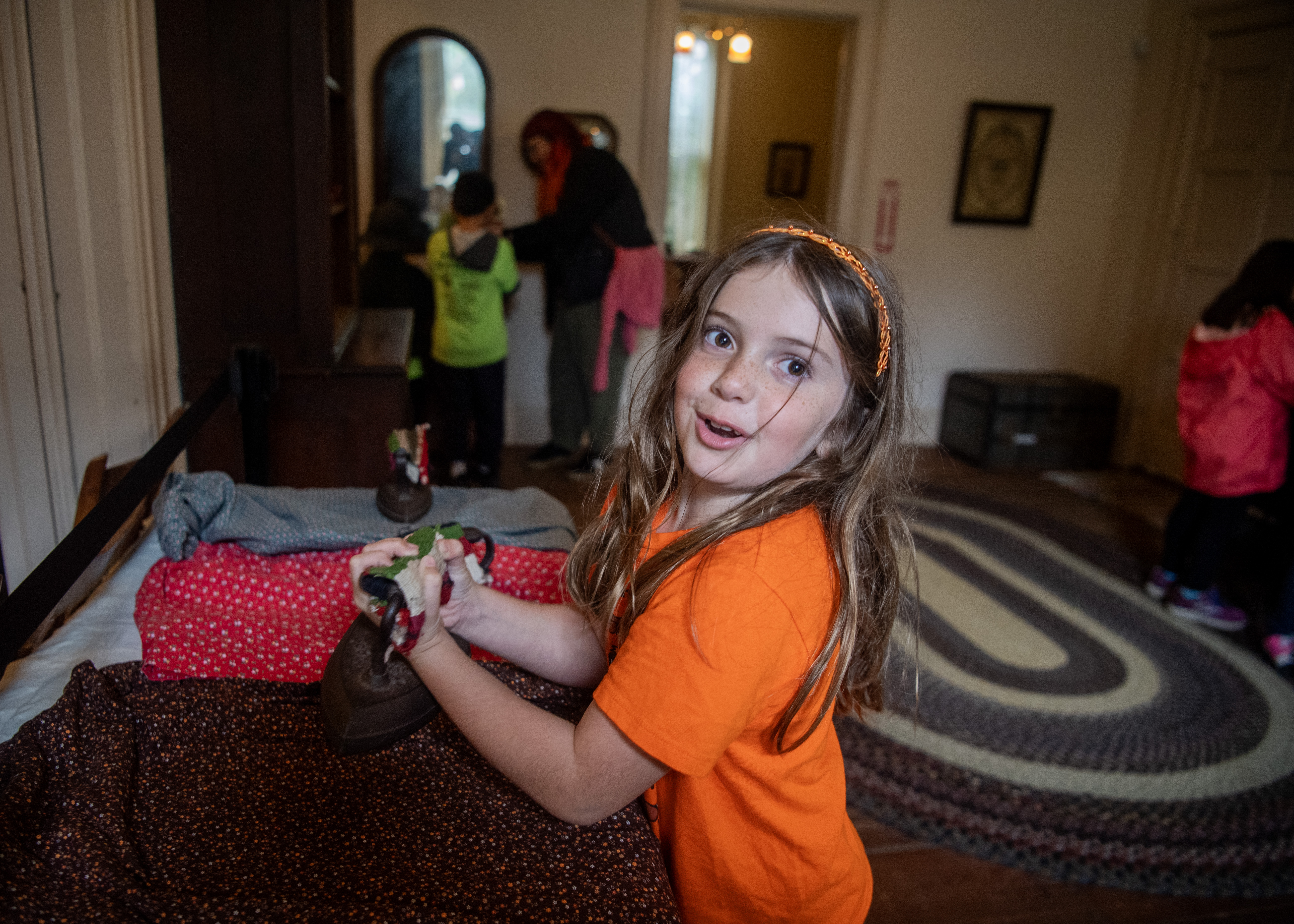 Terrell Elementary School student Lorelei DeMartini holds a turn-of-the-century iron...