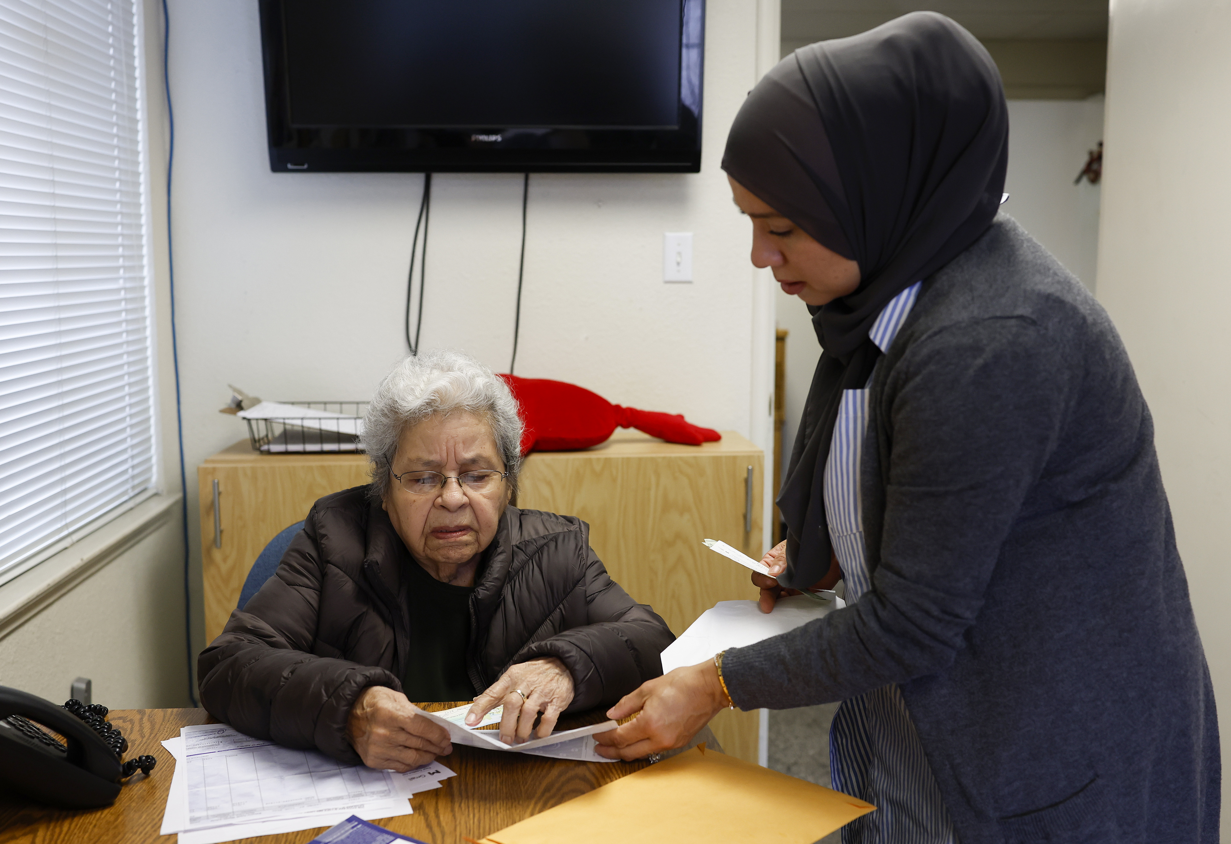 Lidia Donez, left, works with Alma Soto, Executive Director of...