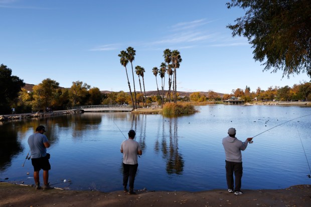 People fish at Santee Lakes Recreation Preserve in Santee in November 2024. (K.C. Alfred / The San Diego Union-Tribune)