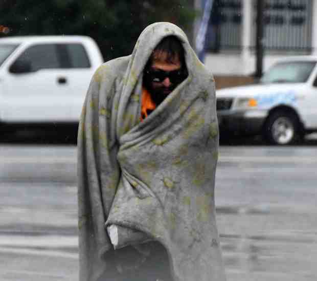 A homeless person in Van Nuys tries to keep dry during a second day of rainstorms on Saturday, Nov 15, 2025. (Photo by Gene Blevins, Contributing Photographer)