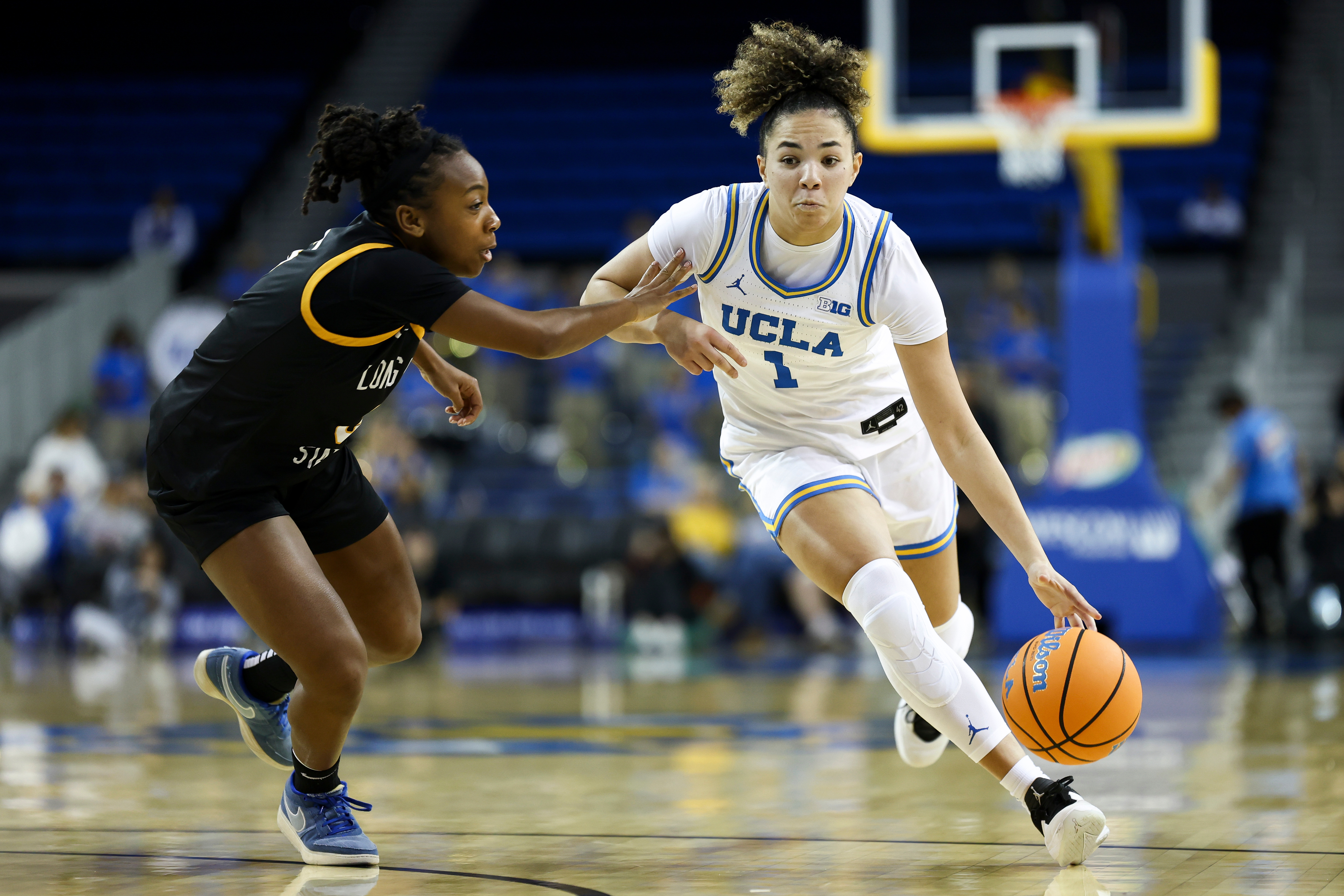 UCLA guard Kiki Rice (1) drives against Long Beach State...