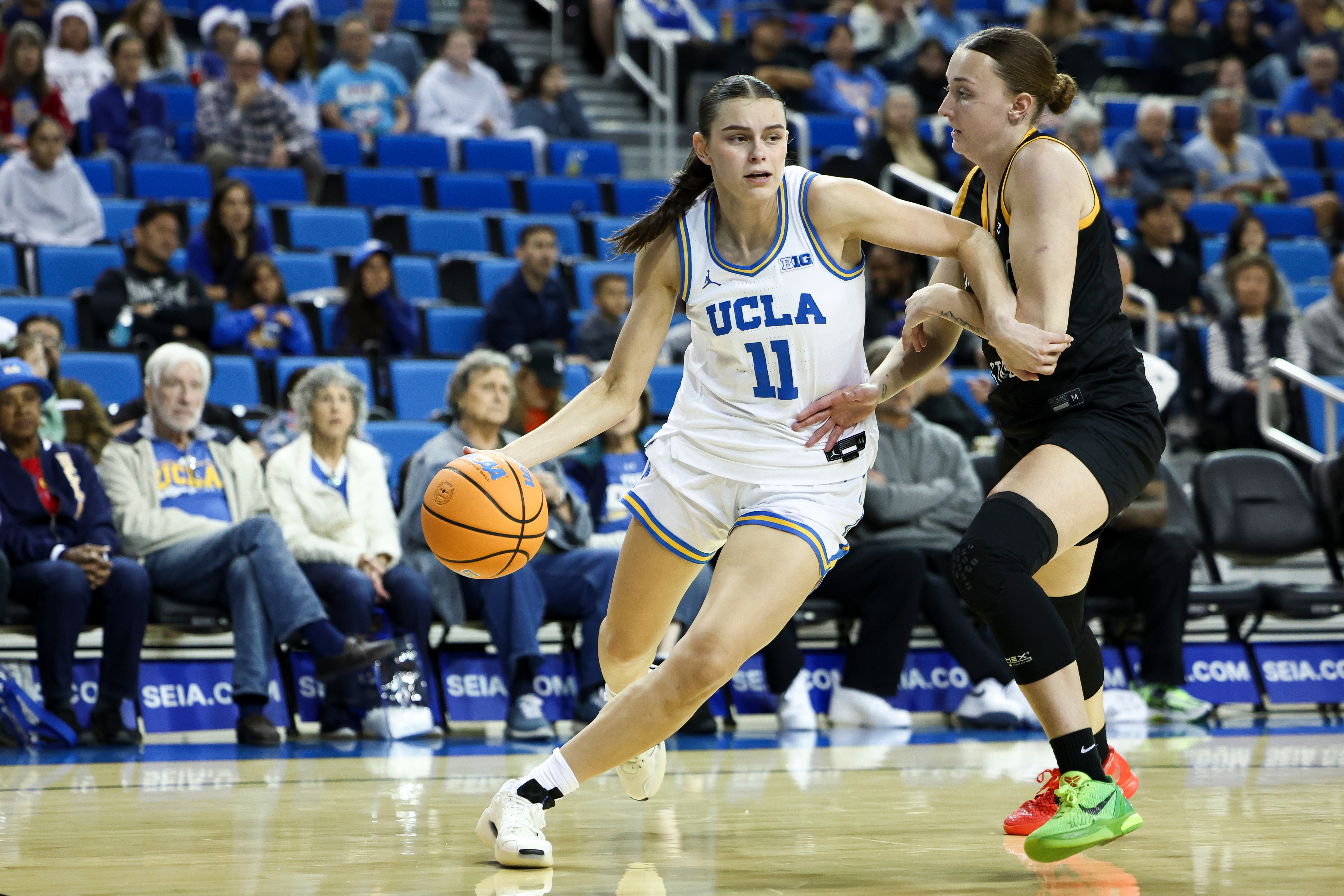 UCLA guard Gabriela Jaquez (11) drives against Long Beach State...