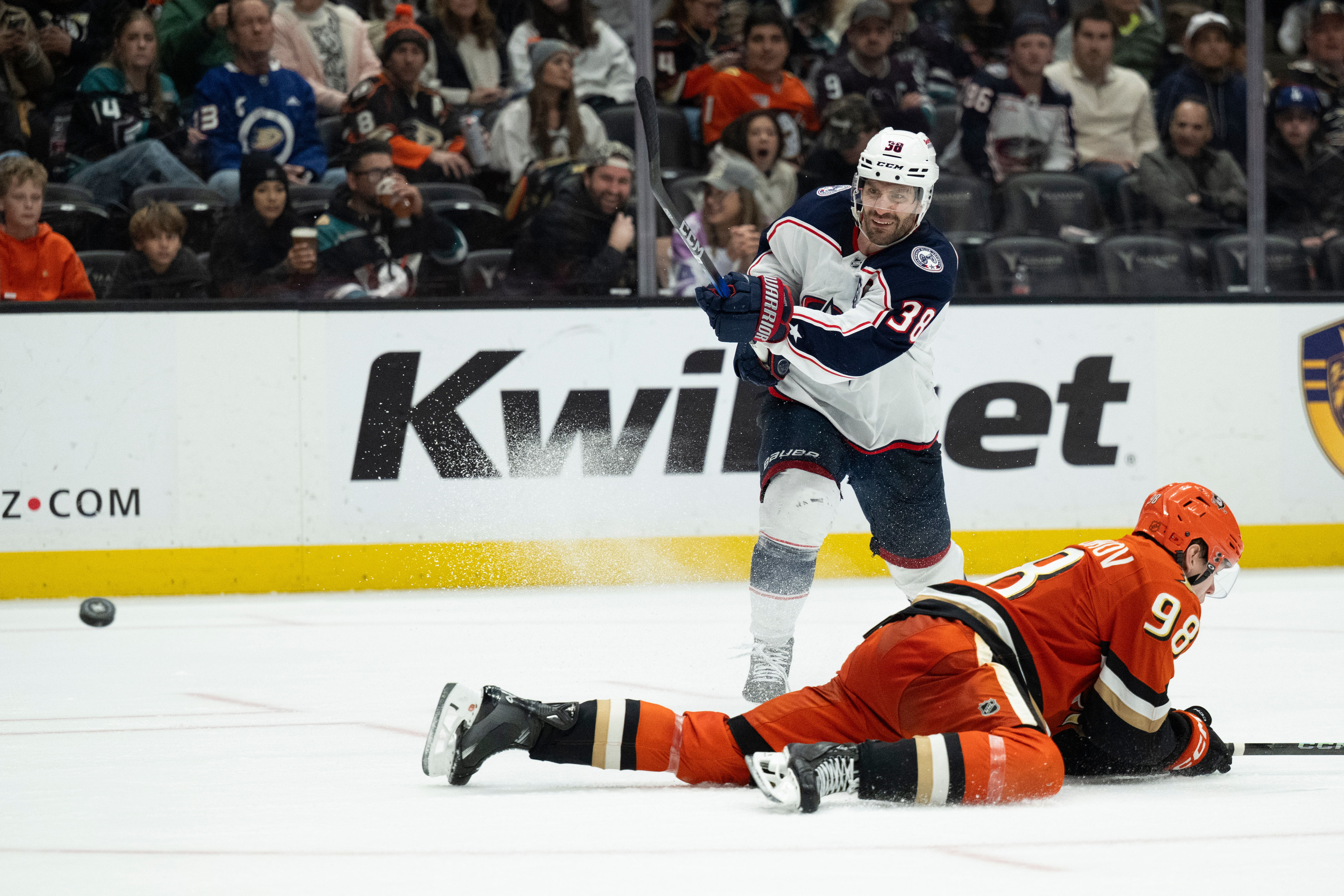 Columbus Blue Jackets center Boone Jenner, top, shoots the puck...