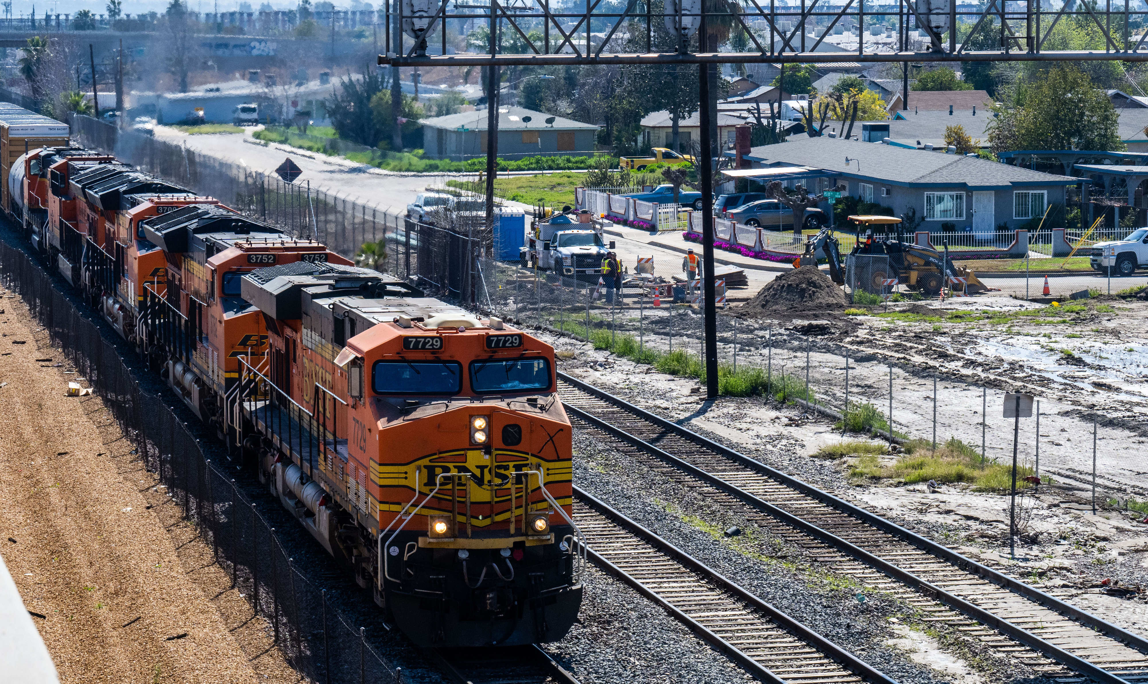 A BNSF freight train moves along the tracks west of...