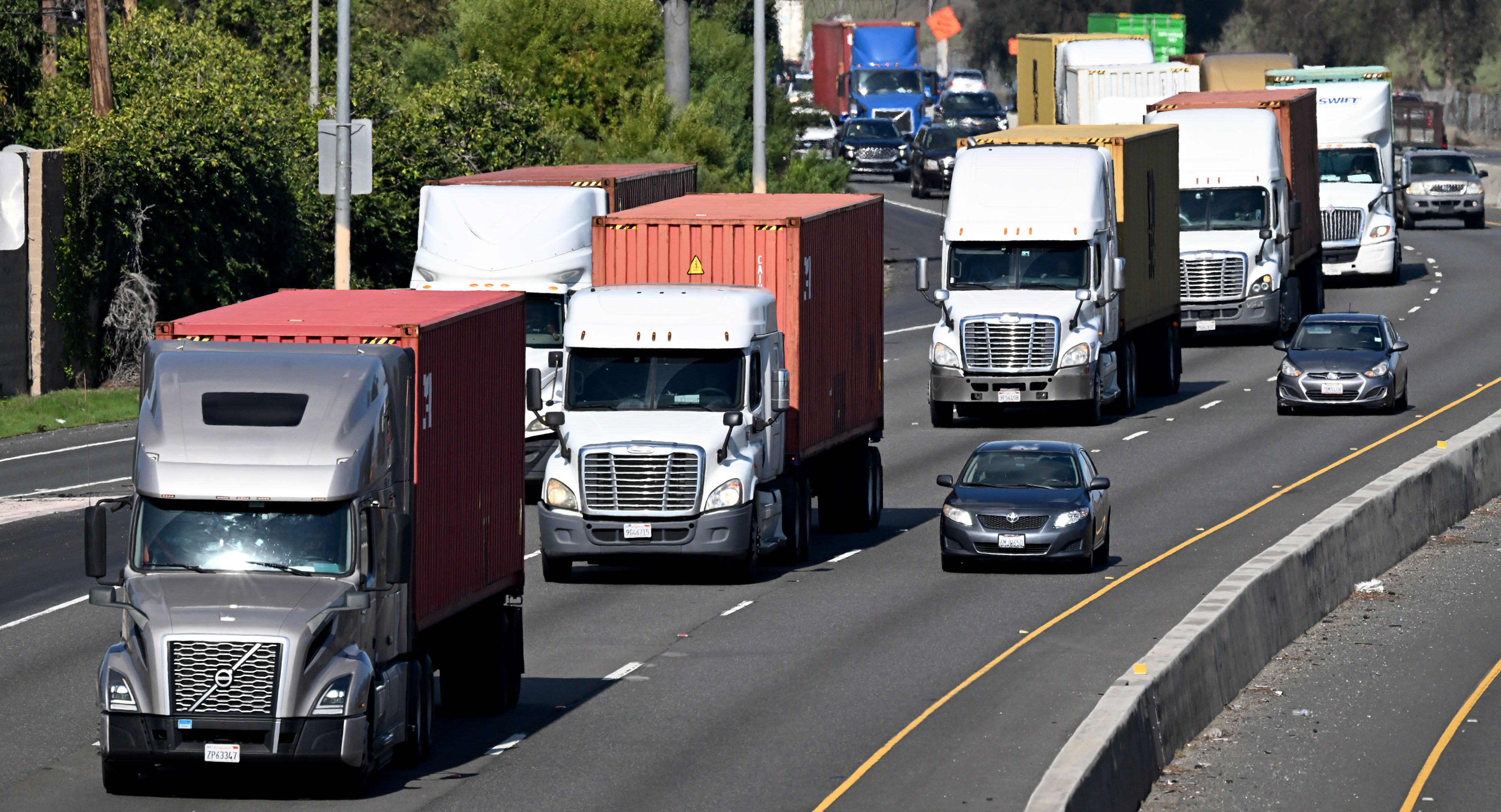 Trucks travel along the 710 freeway in Long Beach near...