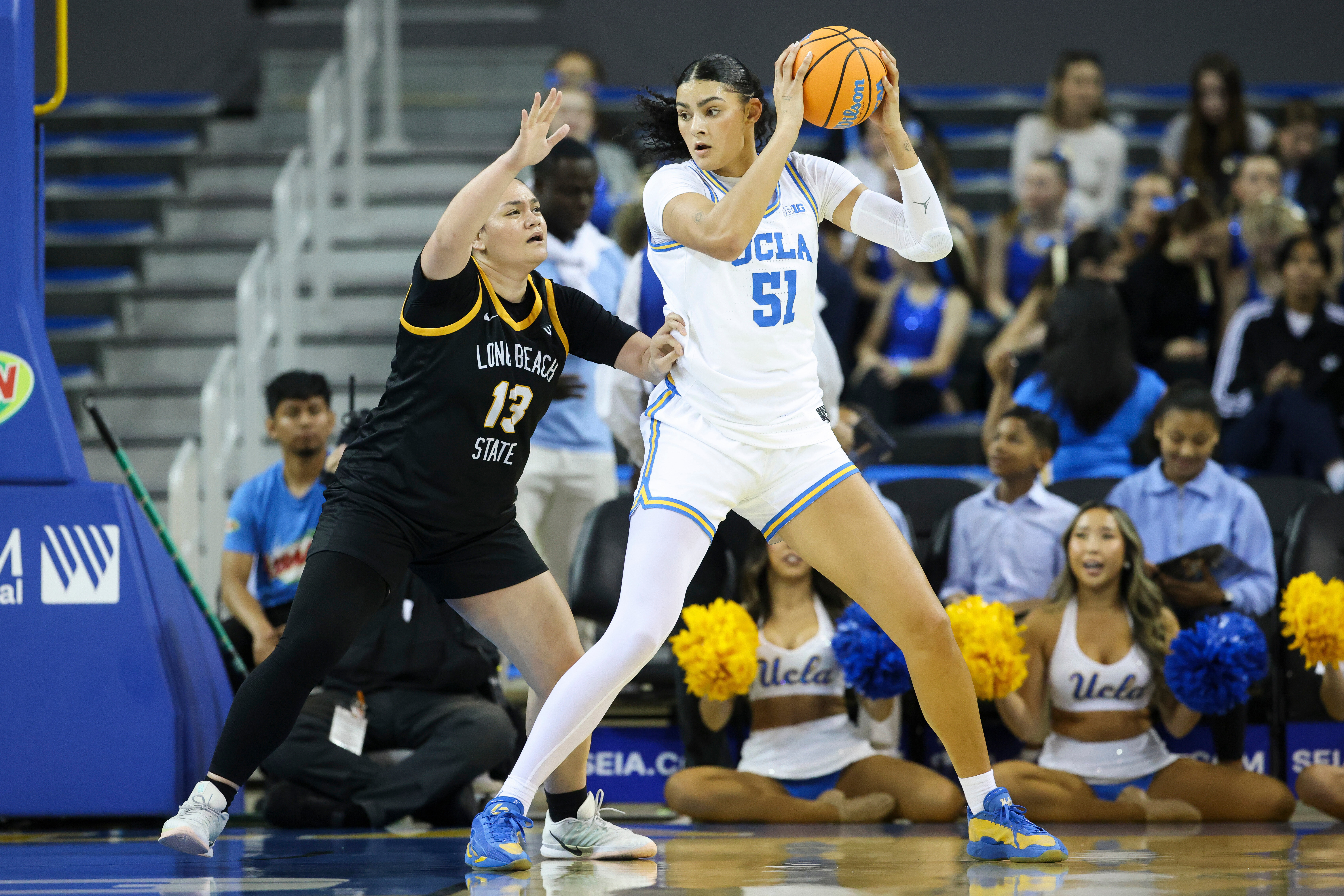 UCLA center Lauren Betts (51) shields the ball from Long...