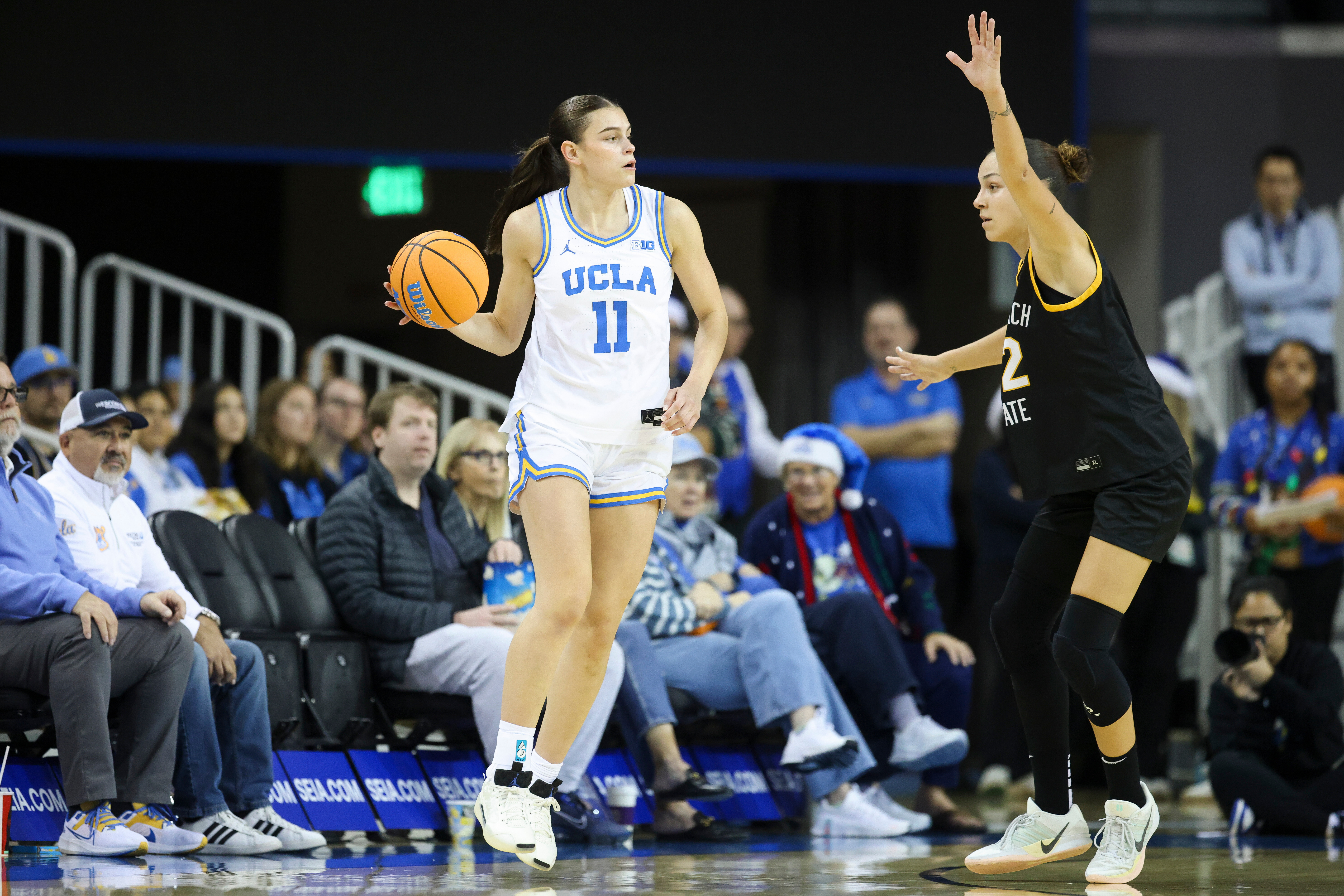 UCLA guard Gabriela Jaquez (11) dribbles against Long Beach State...