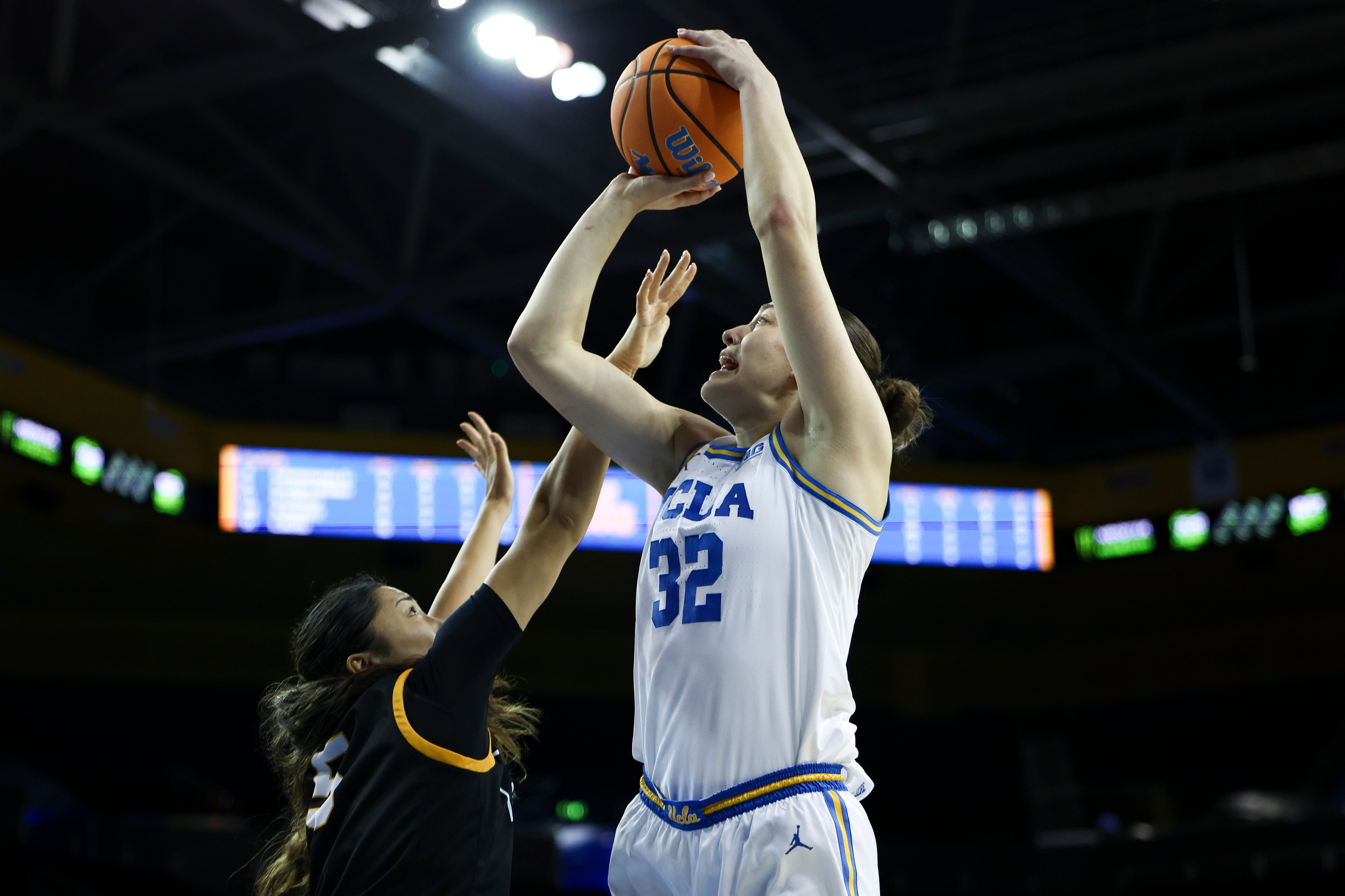 UCLA forward Angela DugaliÄ (32) looks to shoot against Long...