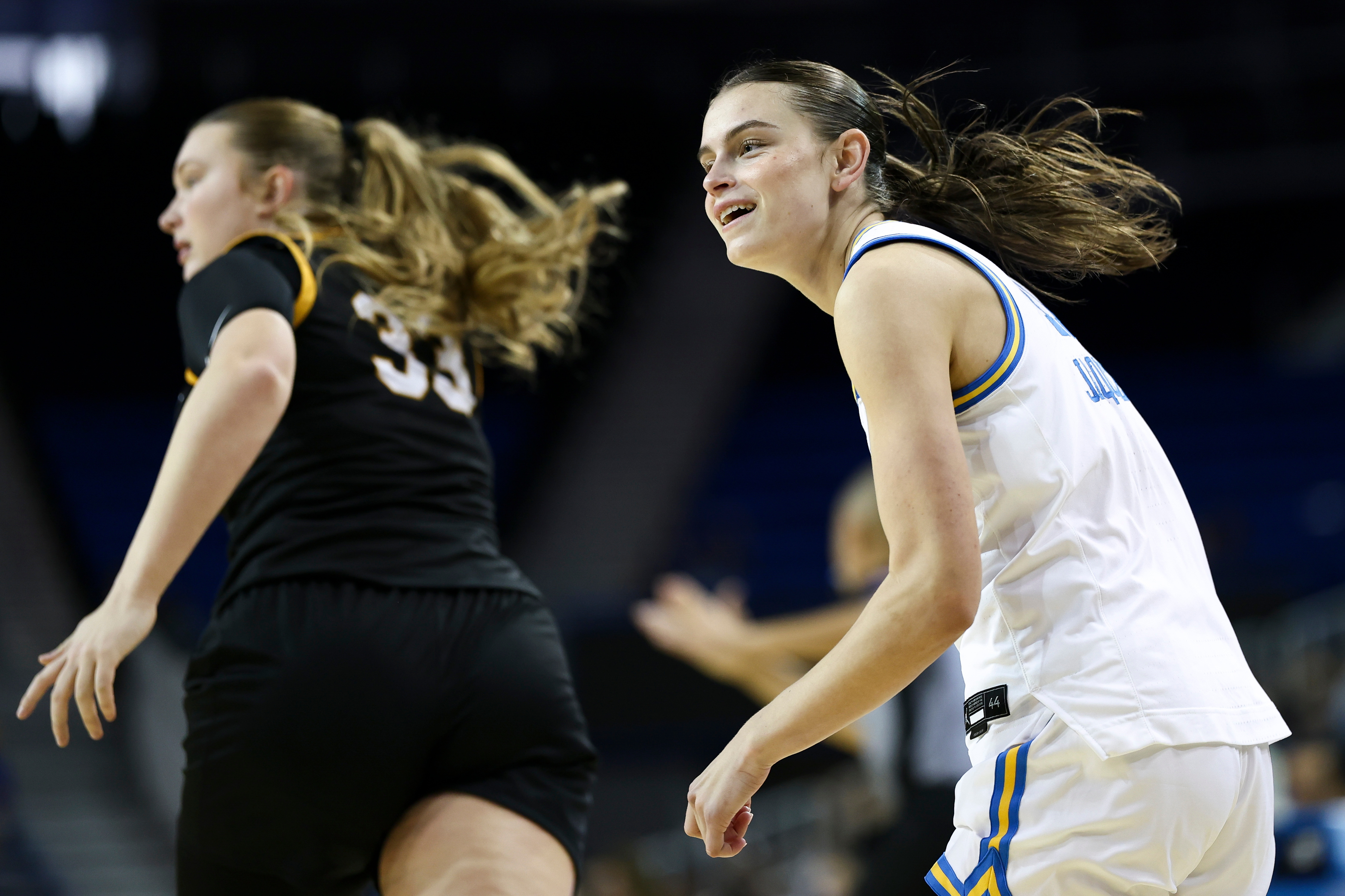 UCLA guard Gabriela Jaquez, right, reacts after making a three...