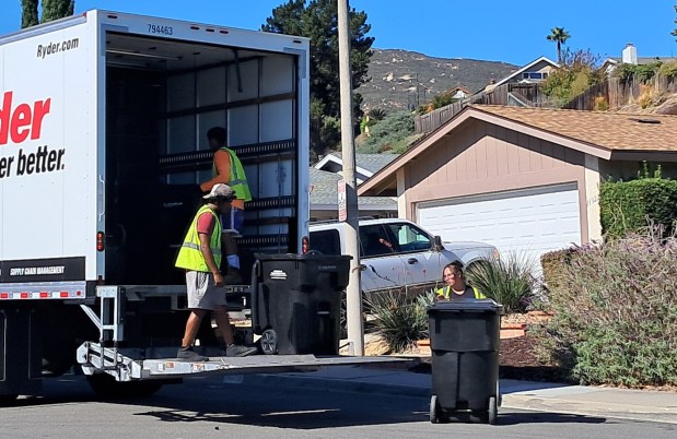 The black trash bins used by the City of San Diego being removed in Rancho Bernardo's Westwood neighborhood on Oct. 28. (Elizabeth Marie Himchak)