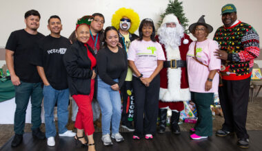 City officials, volunteers, community organizers and Santa Claus take a...
