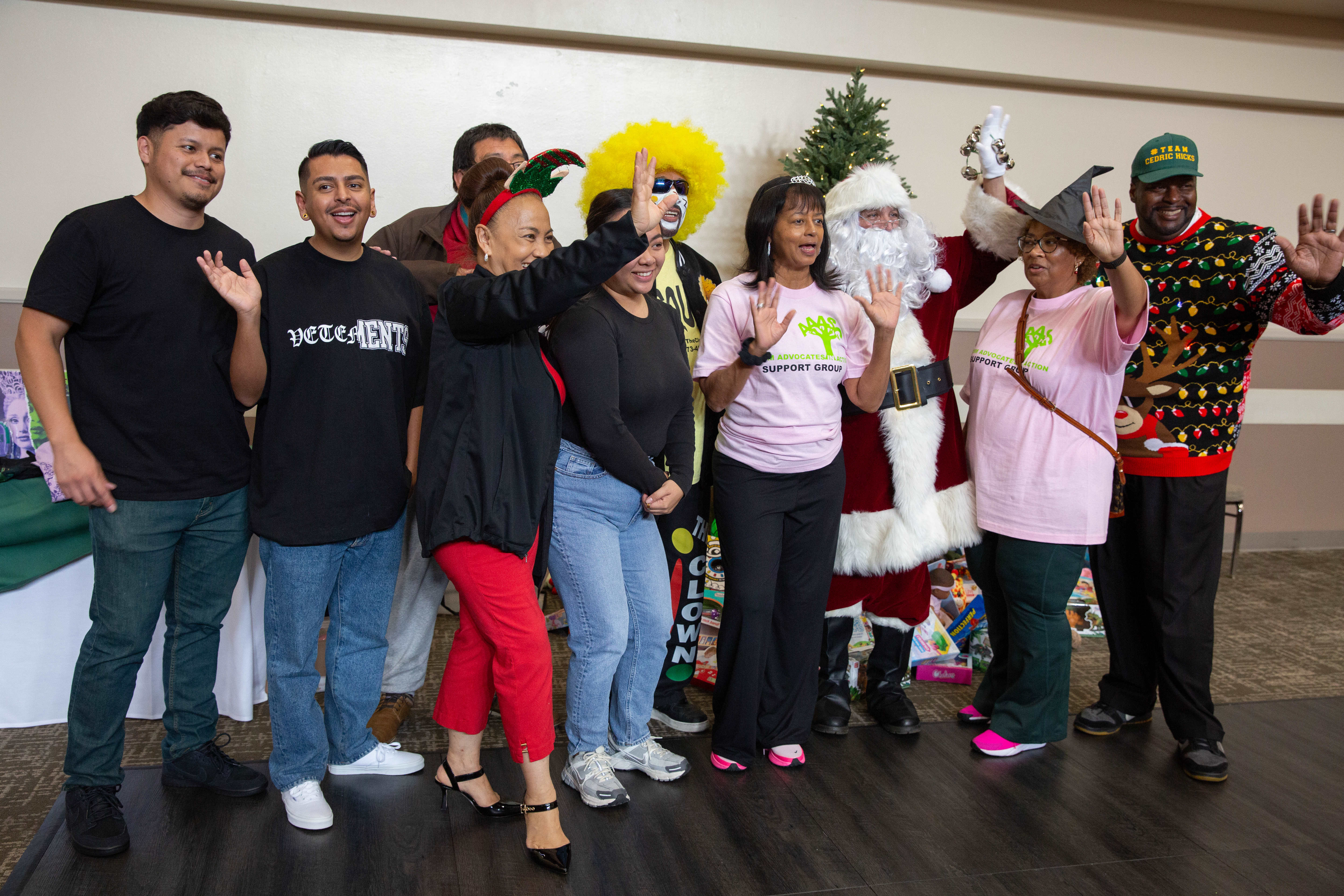 City officials, volunteers, community organizers and Santa Claus take a...