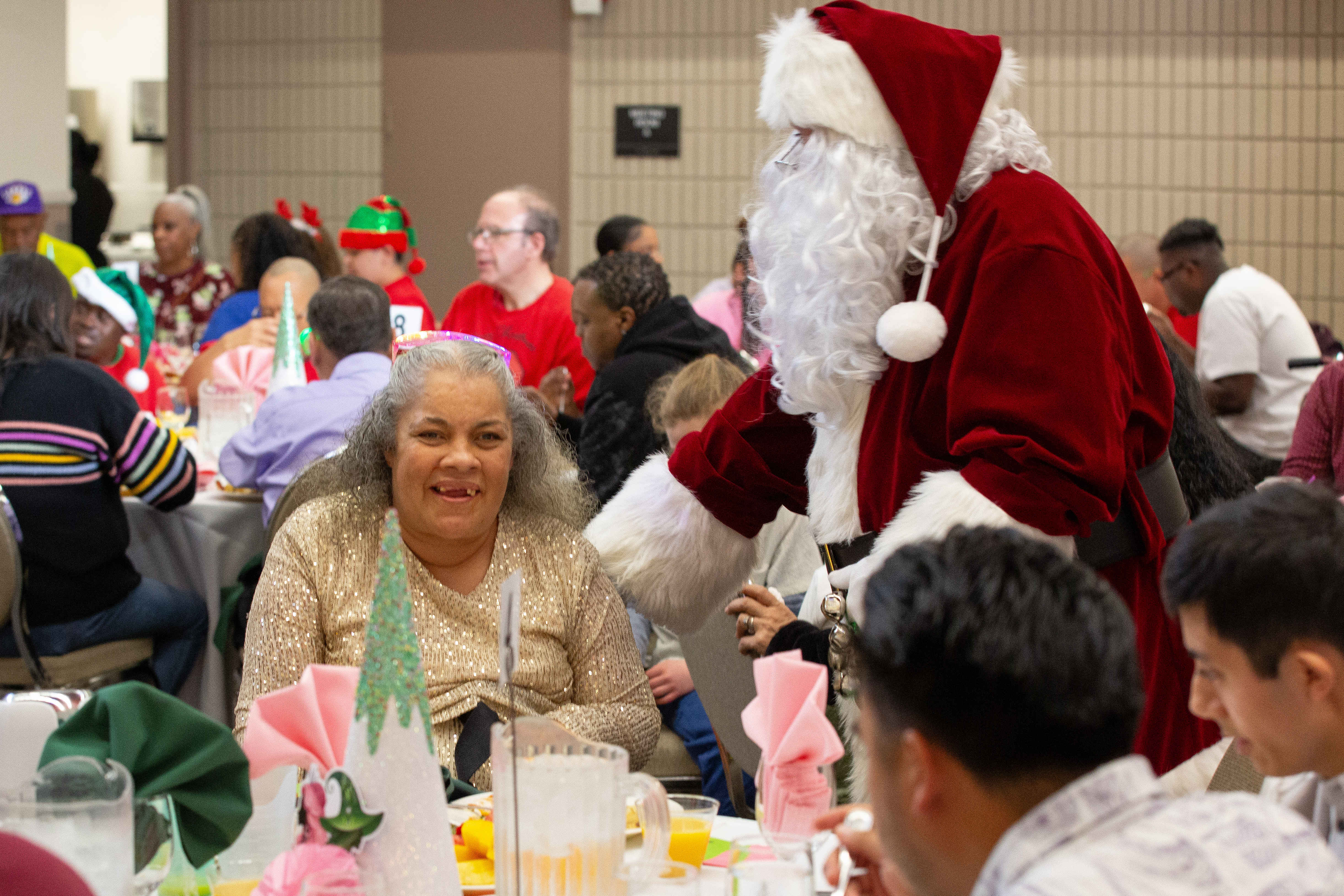 Santa Claus pays a visit to attendees eating food during...