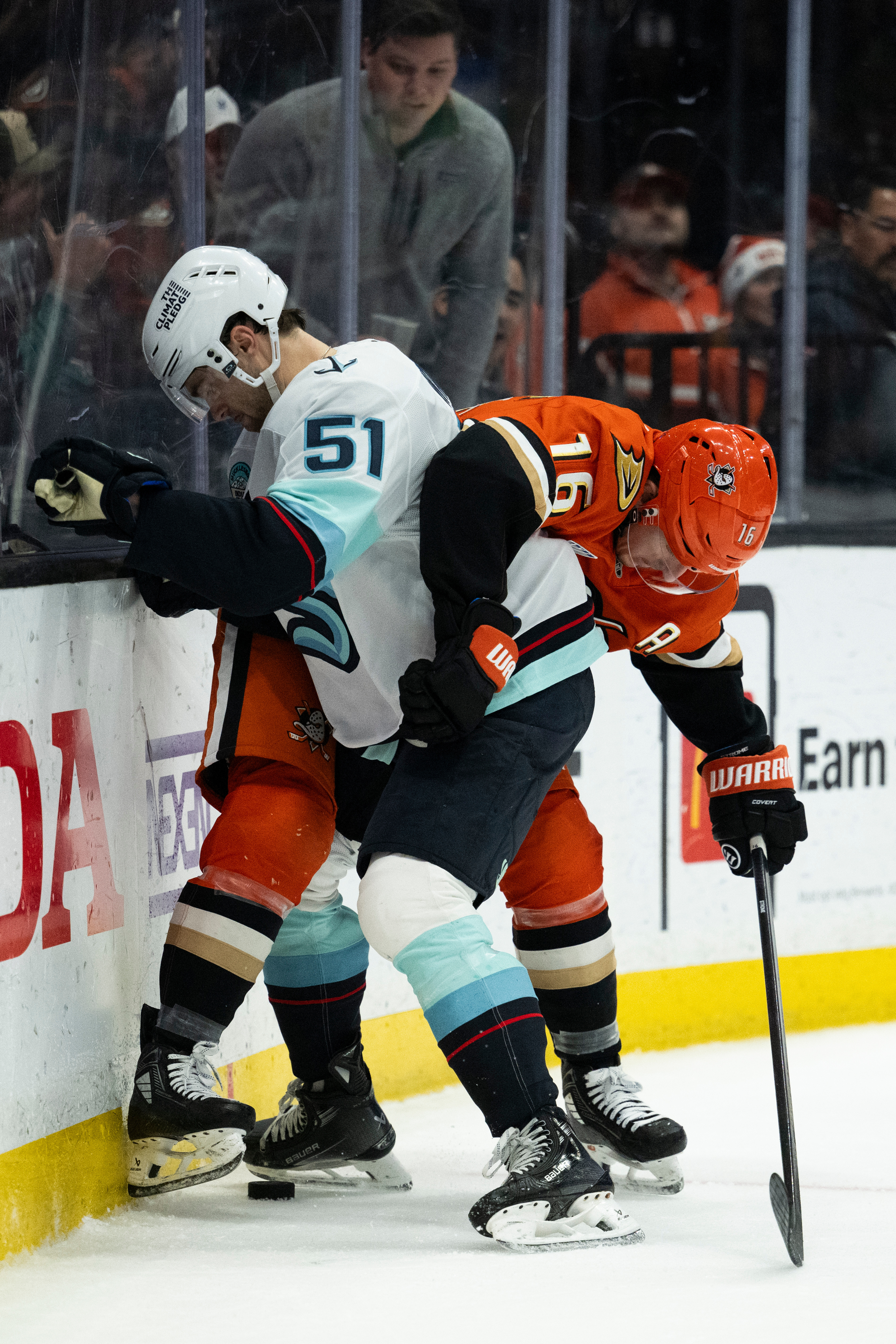 Ducks center Ryan Strome, right, vies for the puck against...