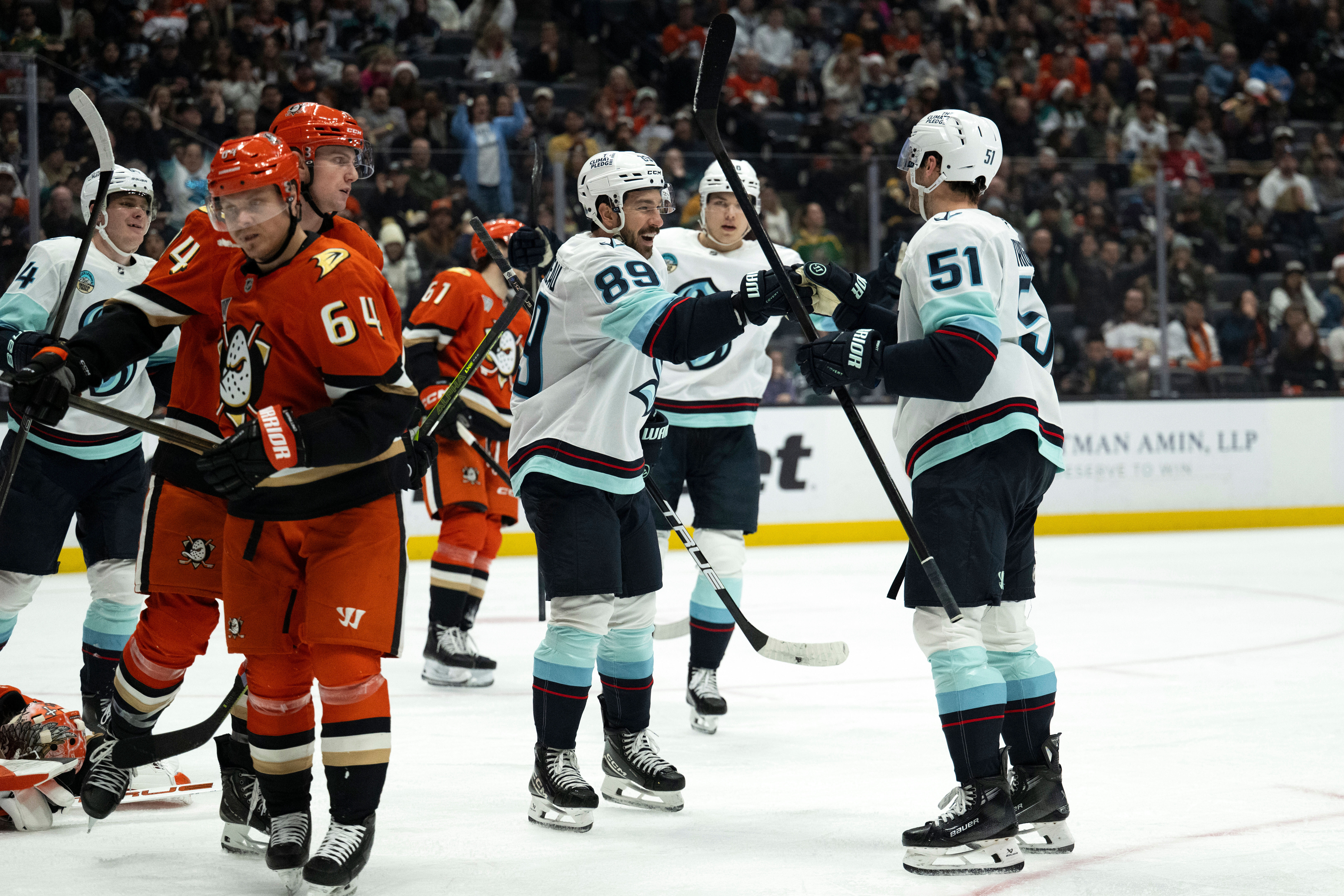 Seattle Kraken center Frederick Gaudreau (89) celebrates with center Shane...