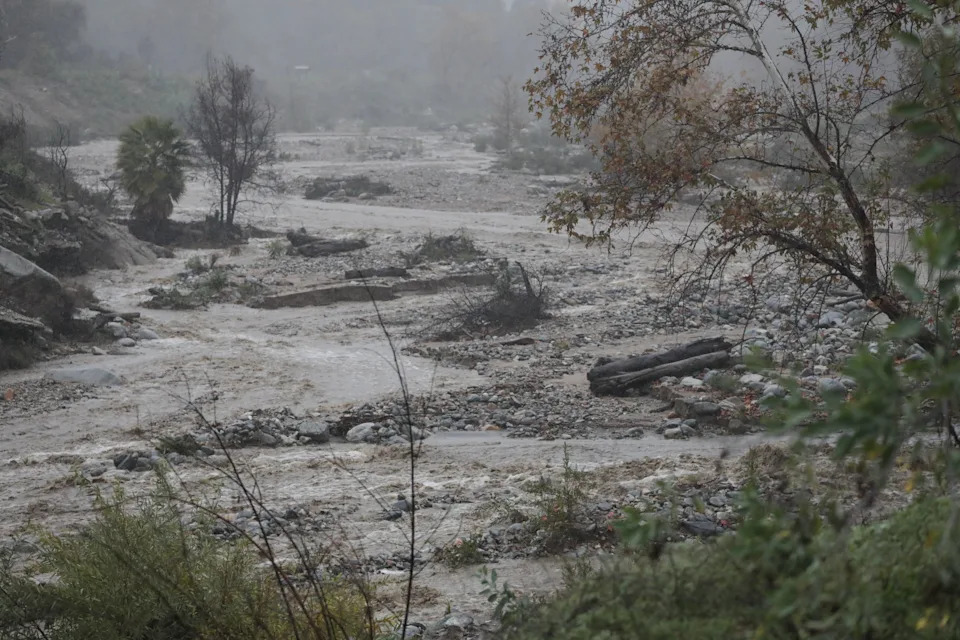 Water levels rise in Eaton Canyon as heavy rain moves through the region during the holiday week in Altadena, California on December 24, 2025.
