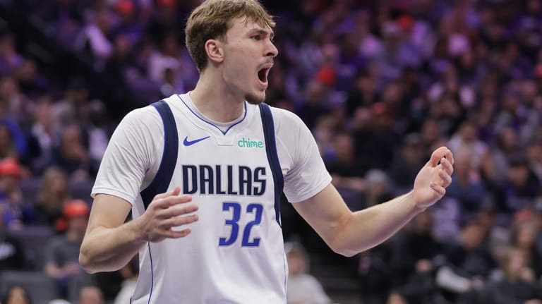 Dallas Mavericks forward Cooper Flagg reacts after being called for...