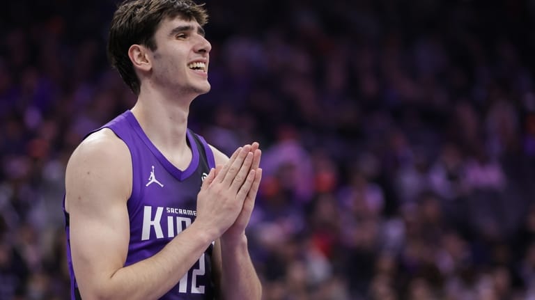 Sacramento Kings center Maxime Raynaud reacts after being called for...
