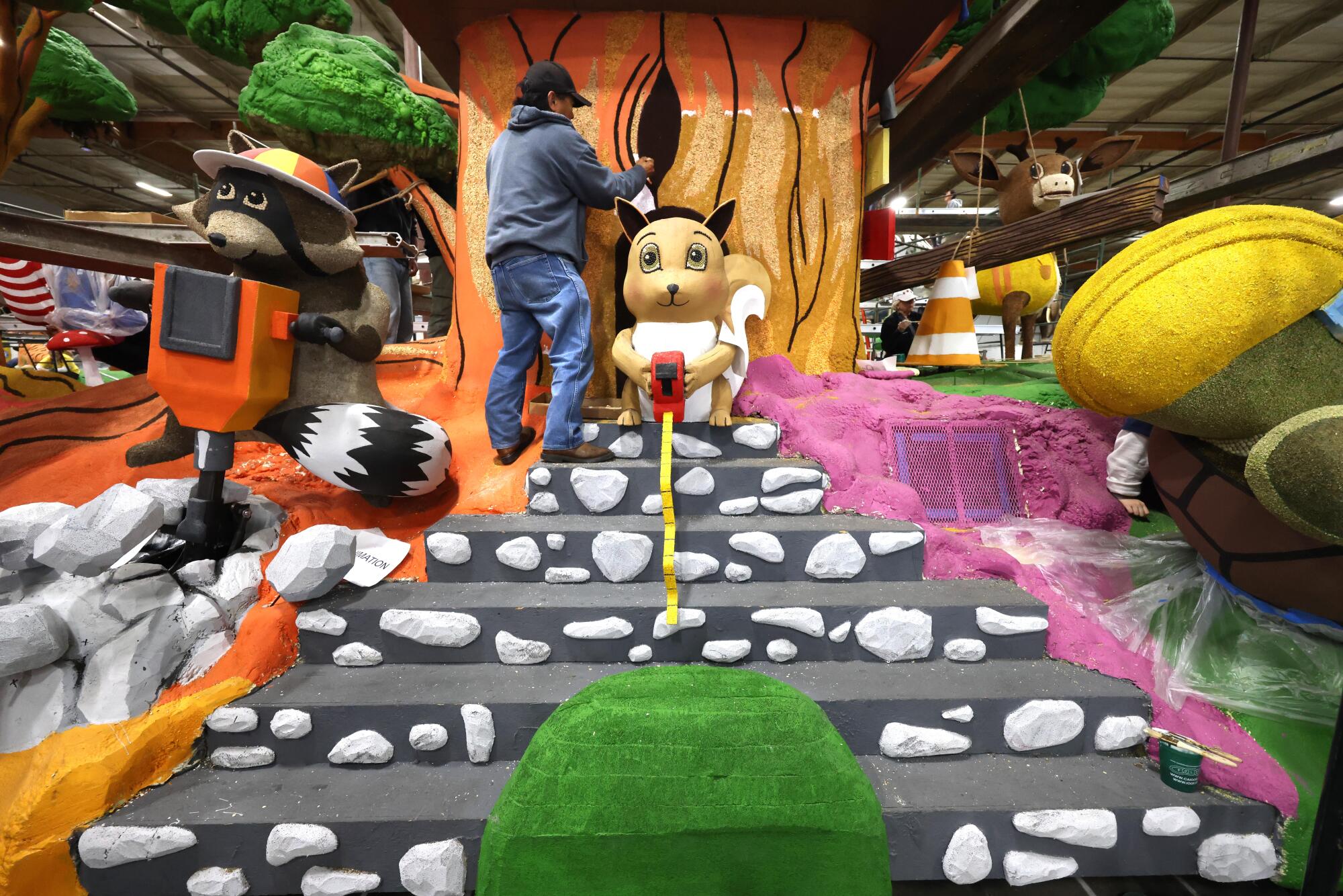 Volunteer Carlos Bo Bedia works on the Shriner's float titled "Building Dreams Together." 