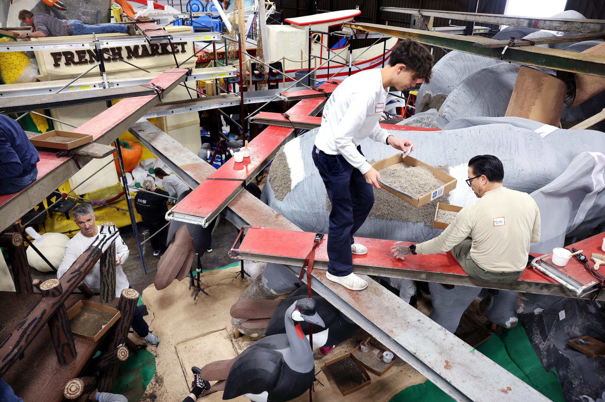 Volunteers apply Spanish moss to an elephant on the San Diego Zoo Safari Park float.