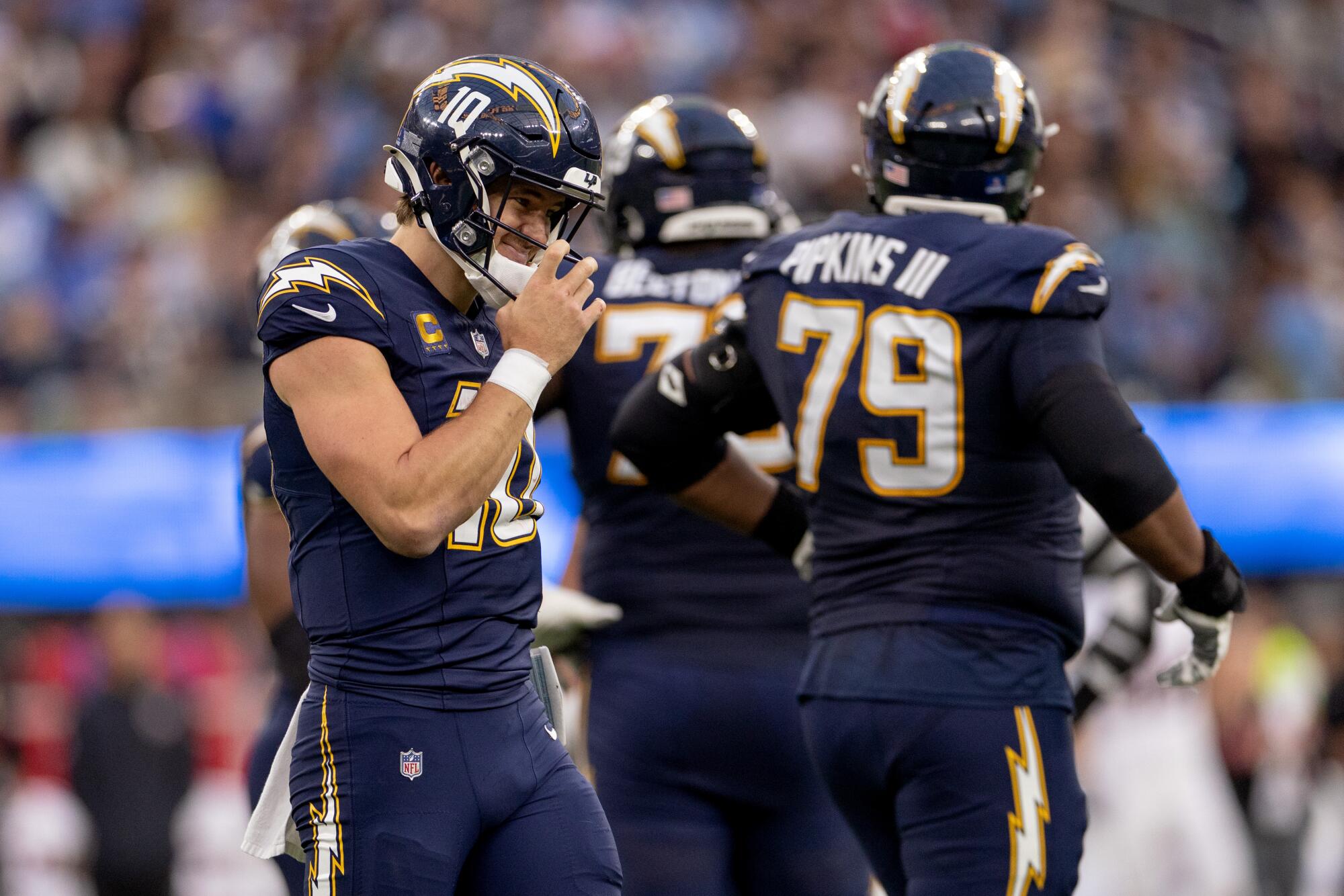 Chargers quarterback Justin Herbert walks on the field during the second half of a 20-16 loss to the Houston Texans.