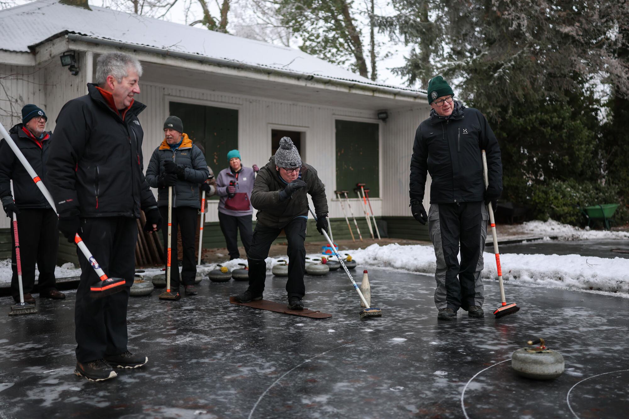 Members of the Highland Curling Club, formed in 1898, play on flooded sheets of ice on Jan. 11 in Inverness, Scotland.