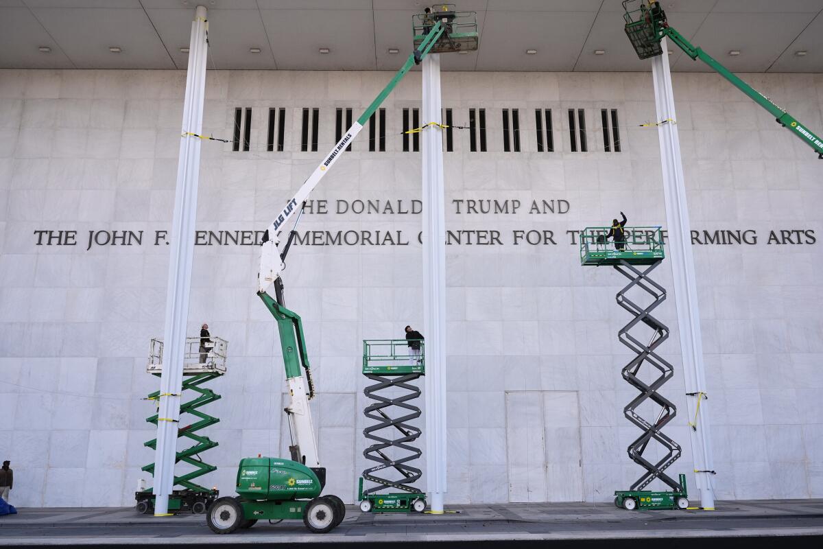 Workers adding Donald Trump's name to the John F. Kennedy Memorial Center for the Performing Arts 